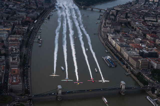 Peter Besenyei of Hungary leads Petr Kopfstein of the Czech Republic, Michael Goulian of the United States, Matt Hall of Australia and Ben Murphy of Great Britain over the city prior to the fourth stage of the Red Bull Air Race World Championship in Budapest, Hungary on June 20, 2018.